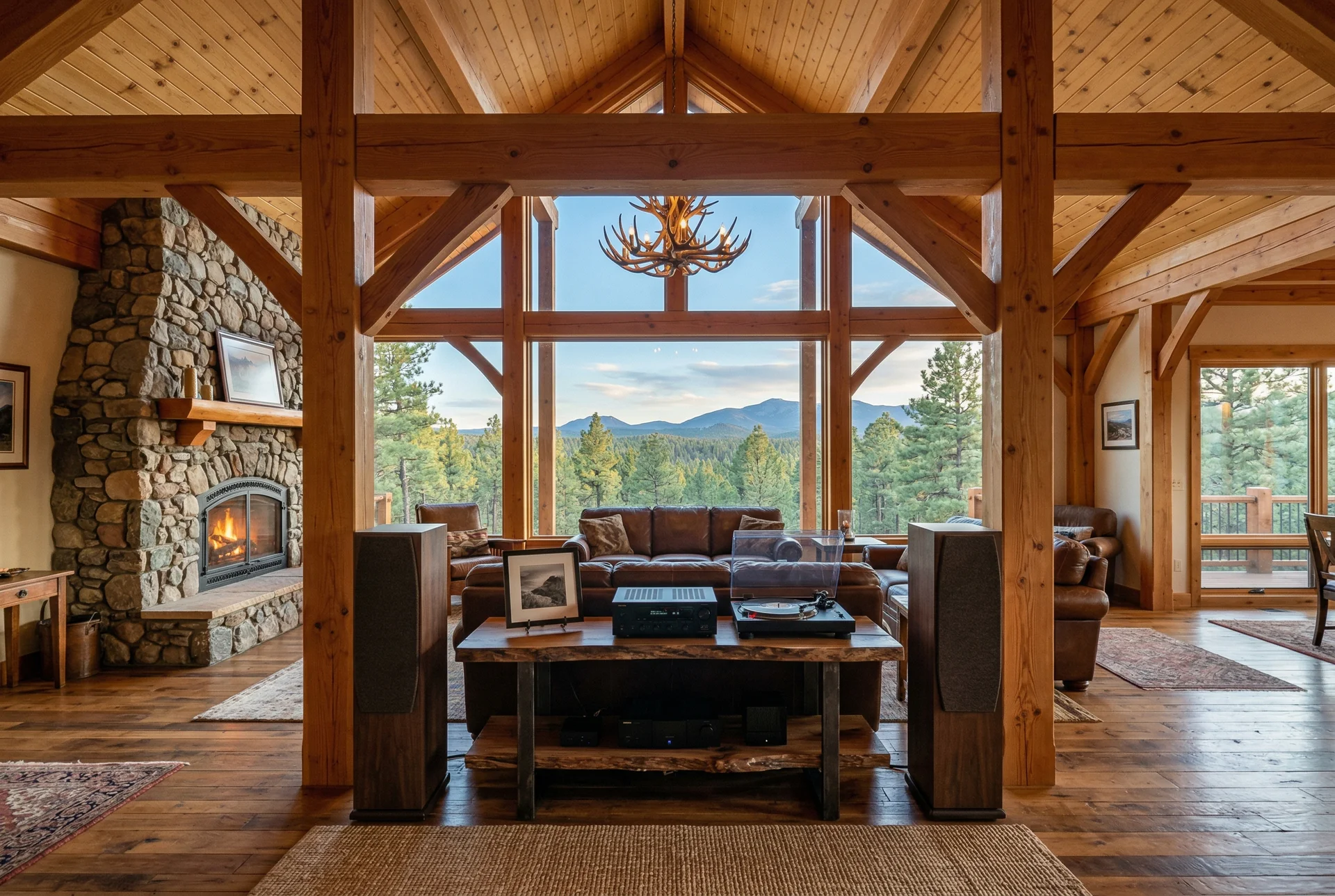 Timber frame great room with tower speakers positioned between massive structural posts in Prescott Arizona