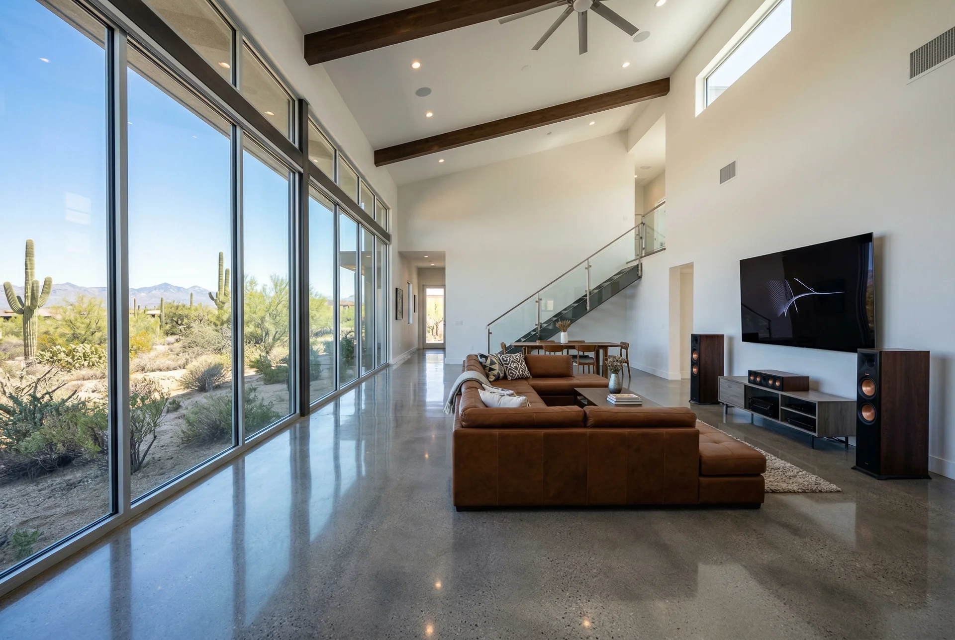 Modern Scottsdale open-concept living room with glass walls and hard surfaces creating acoustic challenges for home theater