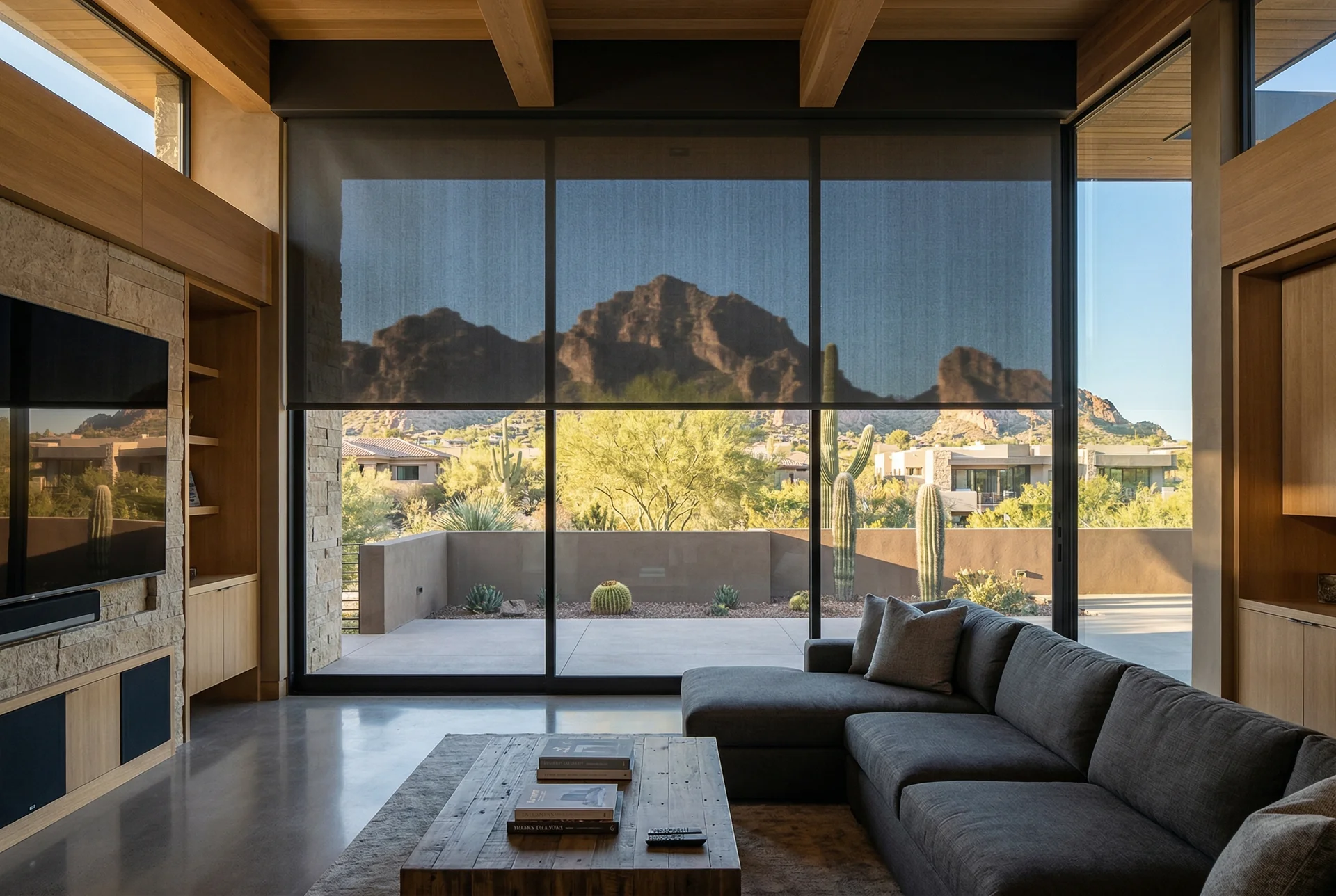 Motorized blackout shade descending over floor-to-ceiling window in media room in Paradise Valley Arizona home