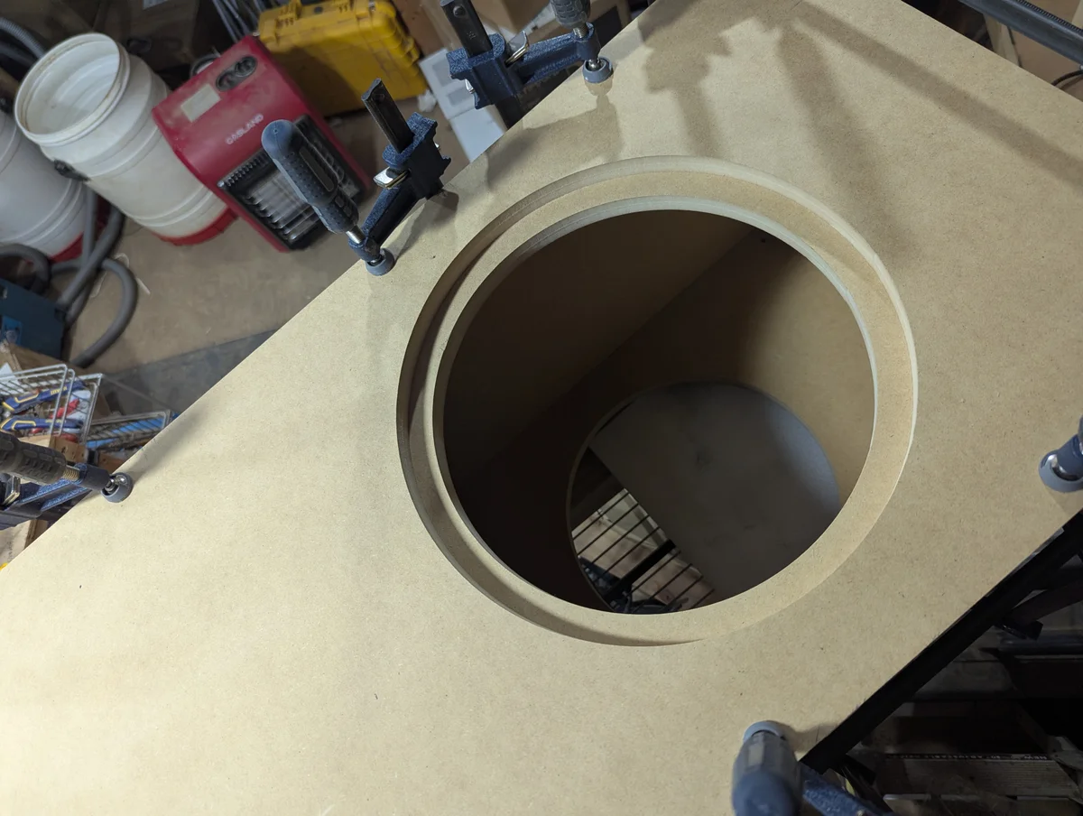Top-down close-up view of a 12-inch subwoofer driver cutout with flush-mount recess machined into double-layer MDF baffle panel for the Wanstreet Scottsdale 2500 watt powered subwoofer enclosure