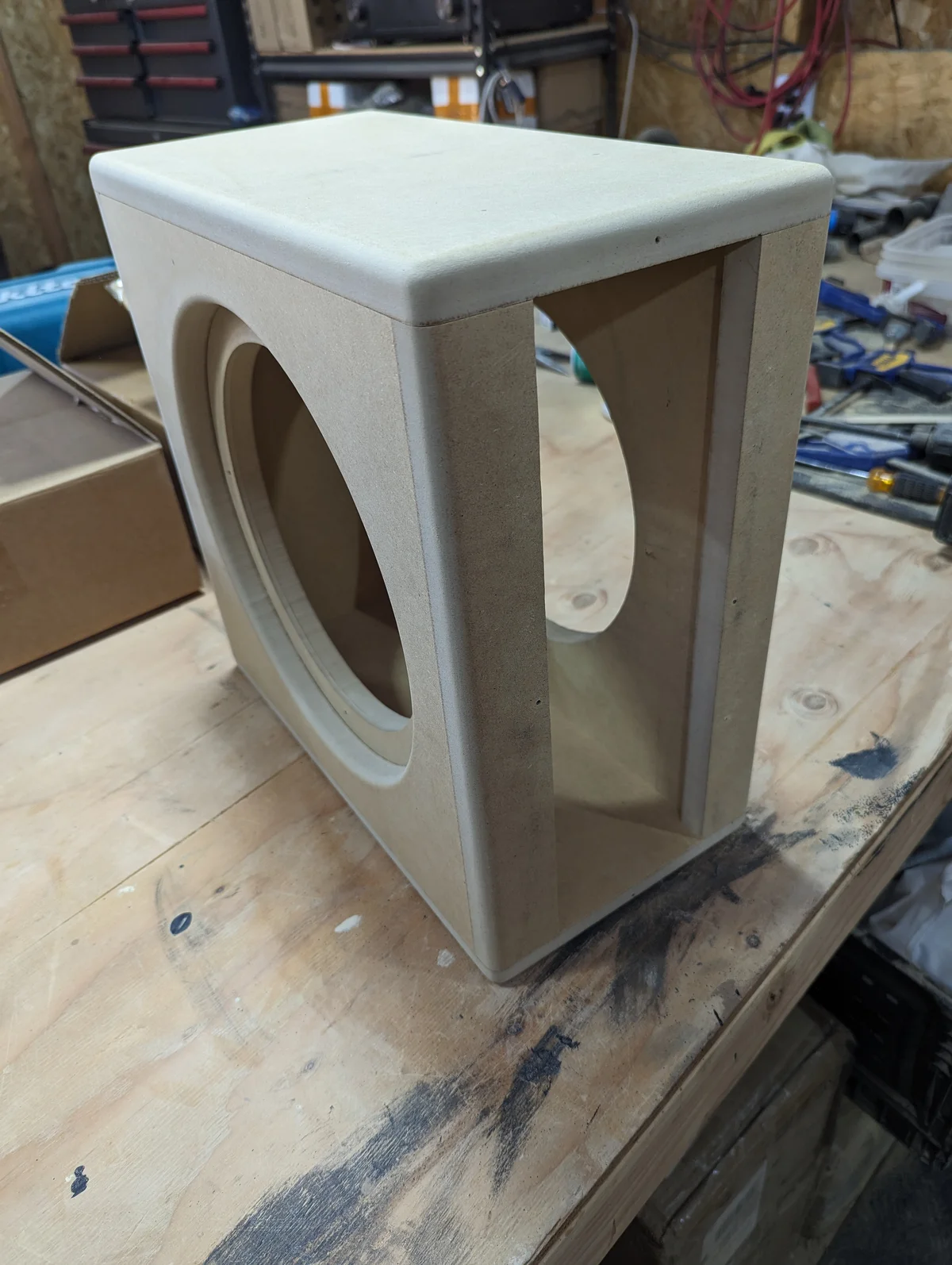 Compact MDF subwoofer cabinet with 10-inch woofer cutout on front face and open rear panel showing internal volume before back panel installation for the Lafferty Prescott Valley 500 watt custom audio build