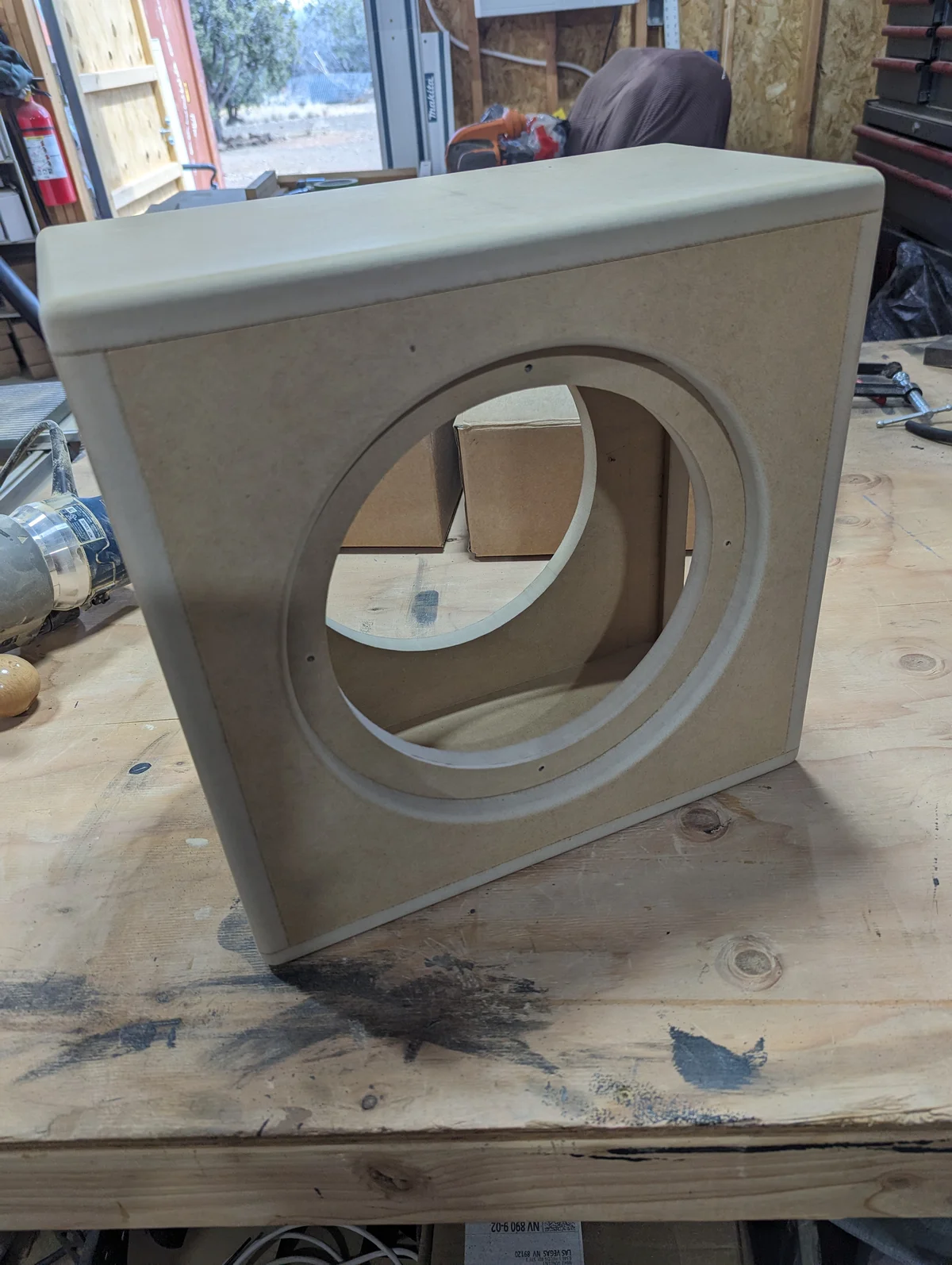 Raw MDF subwoofer cabinet showing 12-inch passive radiator cutout with flush-mount recess on the rear face before finishing for the Lafferty Prescott Valley custom home audio build